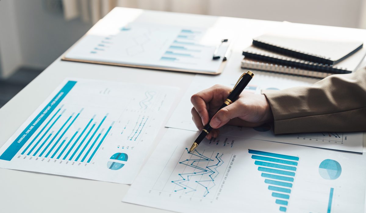 Business accounting woman using calculator for do math finance on wooden desk in office and business working background, tax, accounting, statistics and analytic research concept